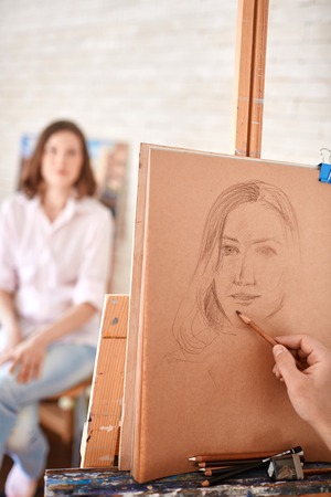 Artist Drawing Sketch of Portrait in Studioの写真素材