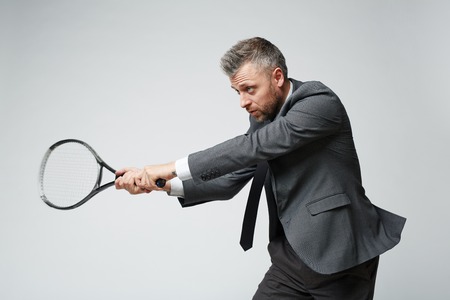 Businessman defending like tennis playerの写真素材