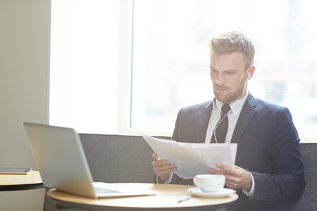 Reading papers in cafeの写真素材