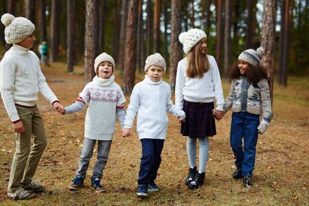 Children Enjoying Walk in Autumn Forestの写真素材