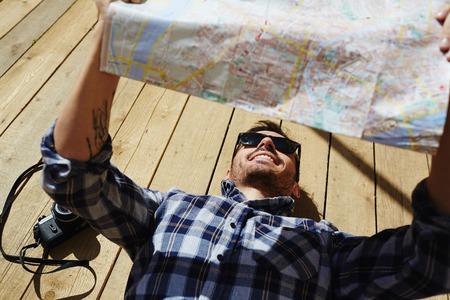 Traveler reading Map in Sunlightの写真素材