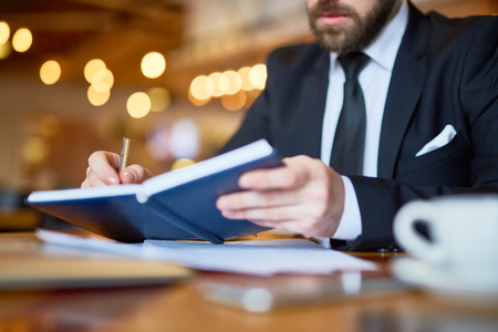 Writing notes in diaryの写真素材