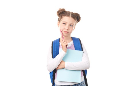 Elementary student with backpack posing against white backgroundの写真素材