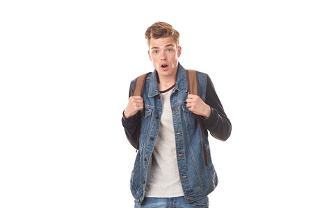 Portrait of schoolboy expressing emotions against white background