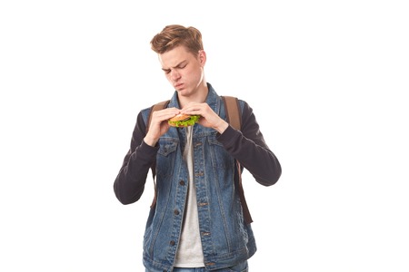 Portrait of student feeling disgust after eating rotten sandwich