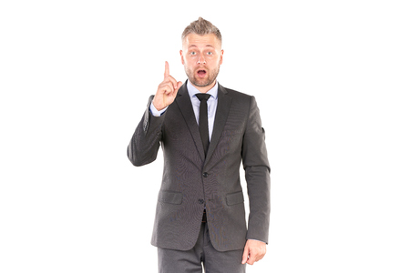 Portrait of middle-aged businessman in elegant suit posing against white backgroundの写真素材
