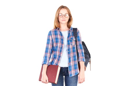 Female teenage student posing with textbook against white backgroundの写真素材