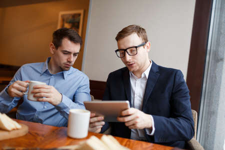 Businessmen in cafeの写真素材