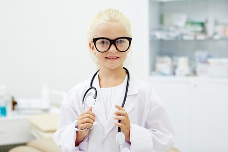 Girl clinician playing doctorの写真素材