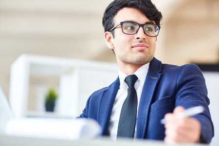 Attentive employee working in officeの写真素材