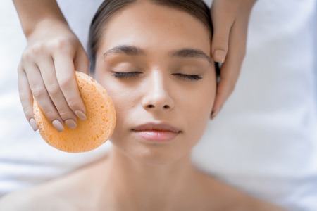 Cleaning face in spaの写真素材