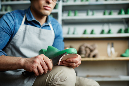 Cutting out shoe soleの写真素材