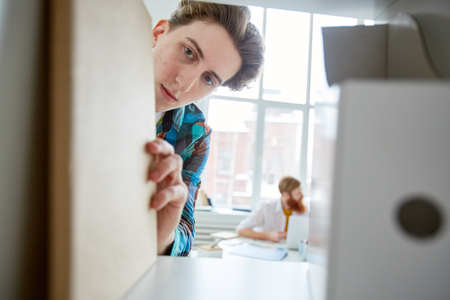 Young manager took a binder from the archives on the shelfの写真素材