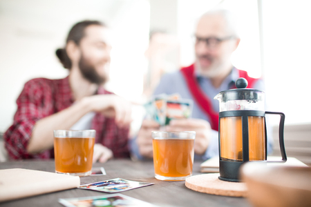 Close-up of hot tea at the table with businessmen in the backgroundの写真素材