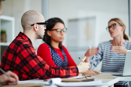 Businessman and businesswoman communicating at the table at meetingの写真素材