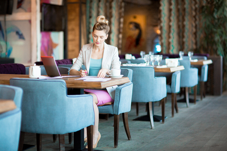 Making notes in cafeの写真素材