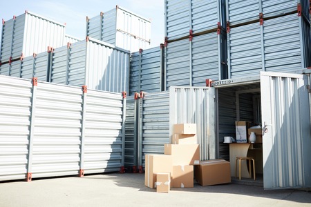 Open storage container with supplies for work and some packed boxes among other onesの写真素材
