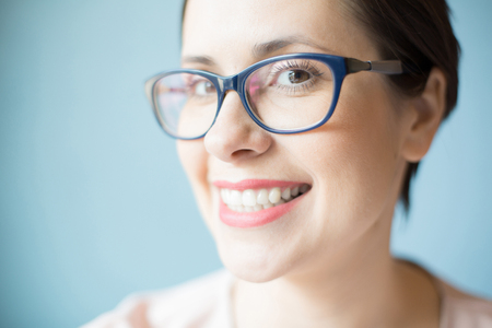 Cheerful woman in glasses looking at cameraの写真素材