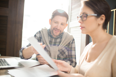 Man showing woman documentsの写真素材