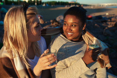 Multiracial women drinking on partyの写真素材
