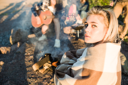 Young woman near fire on partyの写真素材