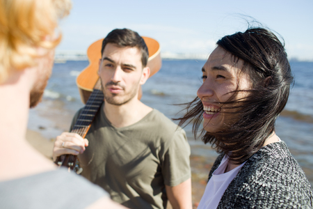 Young men speaking on beachの写真素材