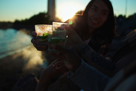 People clinking glasses on beachの写真素材