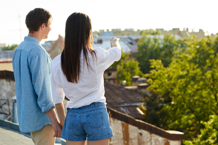 couple viewing from the rooftop.の写真素材