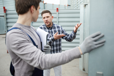 Misunderstanding client talking to storage workerの写真素材