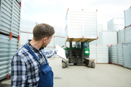Worker showing direction to forklift driverの写真素材