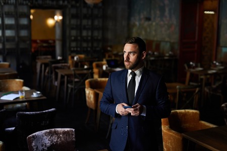 Pensive restaurant owner in empty establishment