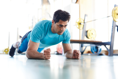 Serious sportsman doing abdomen exercise