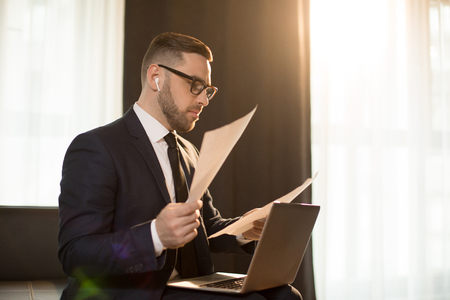 Modern businessman with papers and gadgetsの写真素材