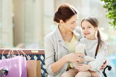 Charming girl with mother in shopping centerの写真素材