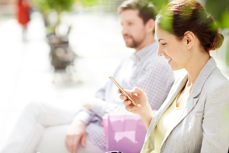 Woman using smartphone in leisureの写真素材
