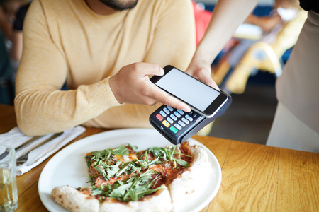 Paying for pizzaの写真素材