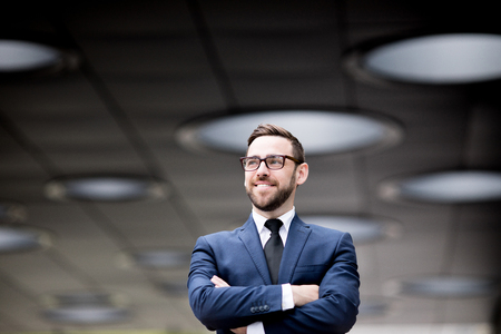 Smiling man crossing handsの写真素材