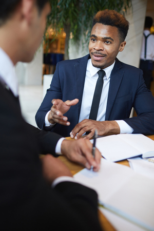 Black businessman explaining his idea to colleagueの写真素材