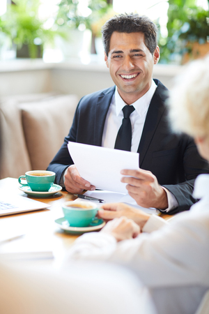 Cheerful lawyer talking to client in cafeの写真素材