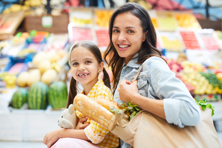 Beautiful family doing shopping at farmers marketの写真素材
