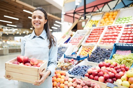 Excited grocery retailer selling fresh fruits and vegetablesの写真素材