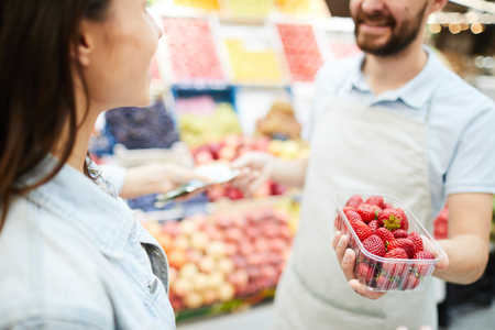 Grocery retailer selling fresh strawberryの写真素材