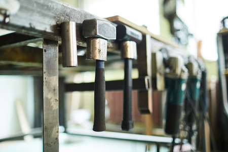 Hammers hanging on metal bar