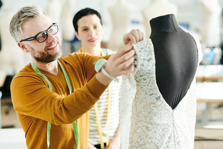 Pinning up sleeve of dressの写真素材