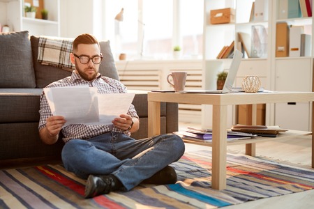 Reading papers at homeの写真素材