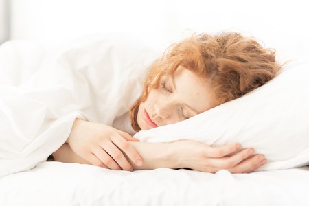 Girl sleeping in bedの写真素材