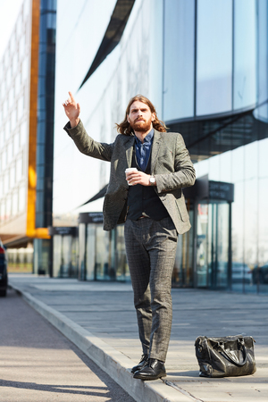 Man by road waiting for busの写真素材