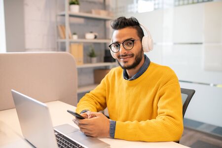 Content marketer checking phone in office