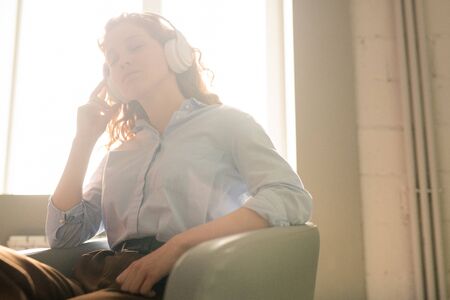 Relaxed woman listening to music in headphonesの写真素材