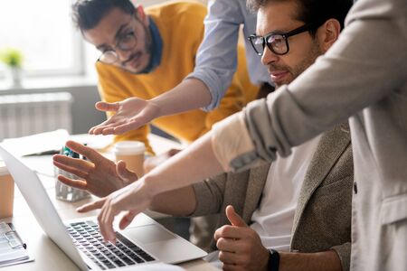 Workers Discussing web design in office